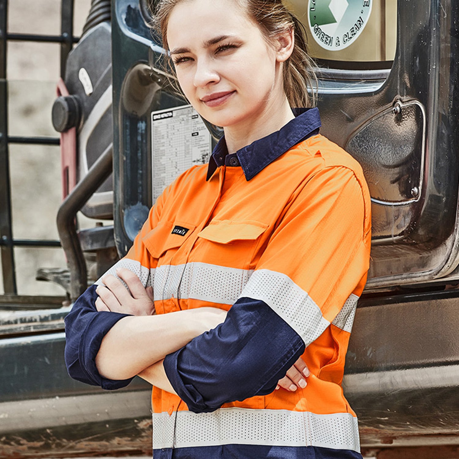 Female worker wearing Look Design custom branded Hi Vis in bright orange and navy with reflective silver stripes