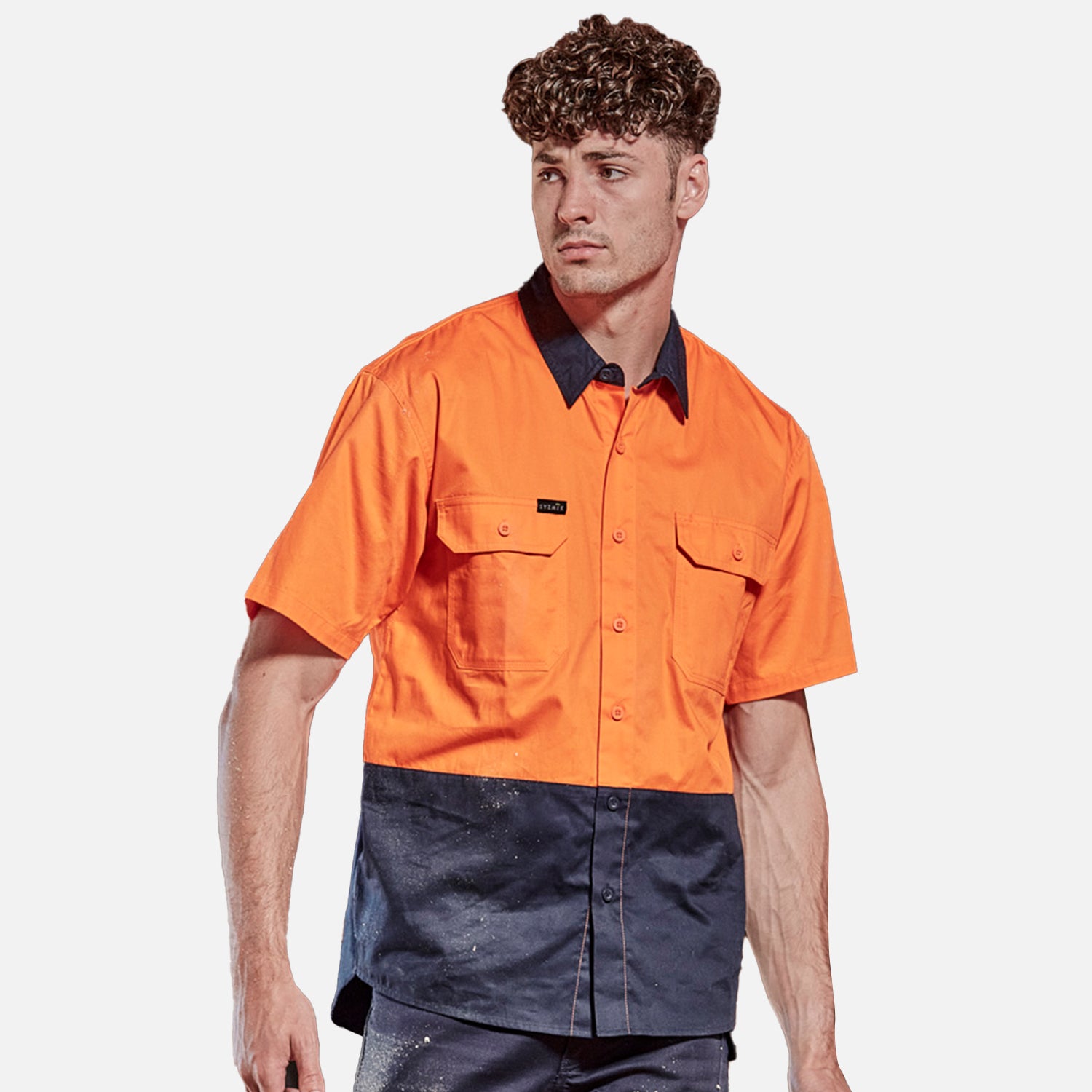 Female worker wearing Look Design custom branded collared Hi Vis in bright orange and navy