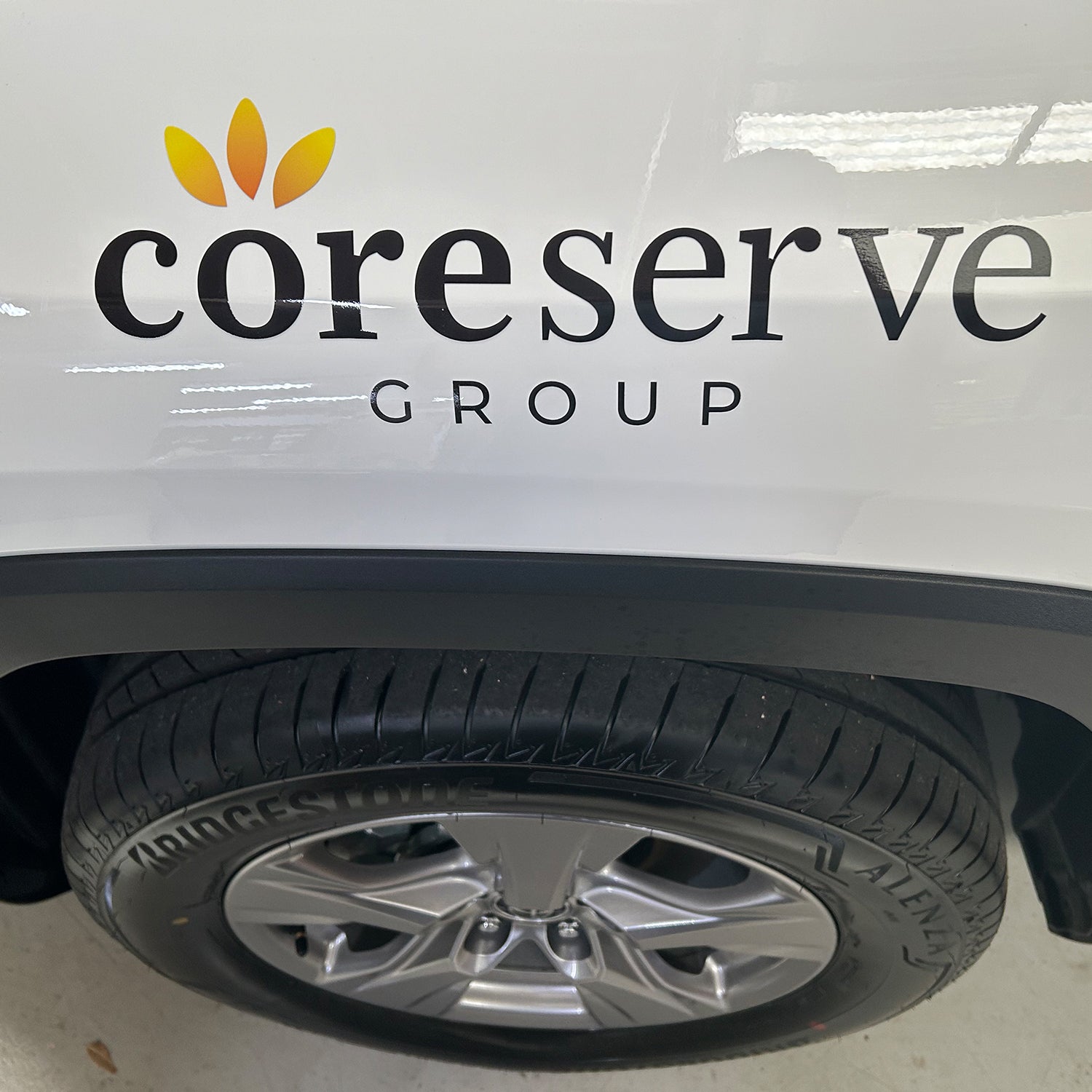 Look Design custom branded vehicle signage on a white vehicle