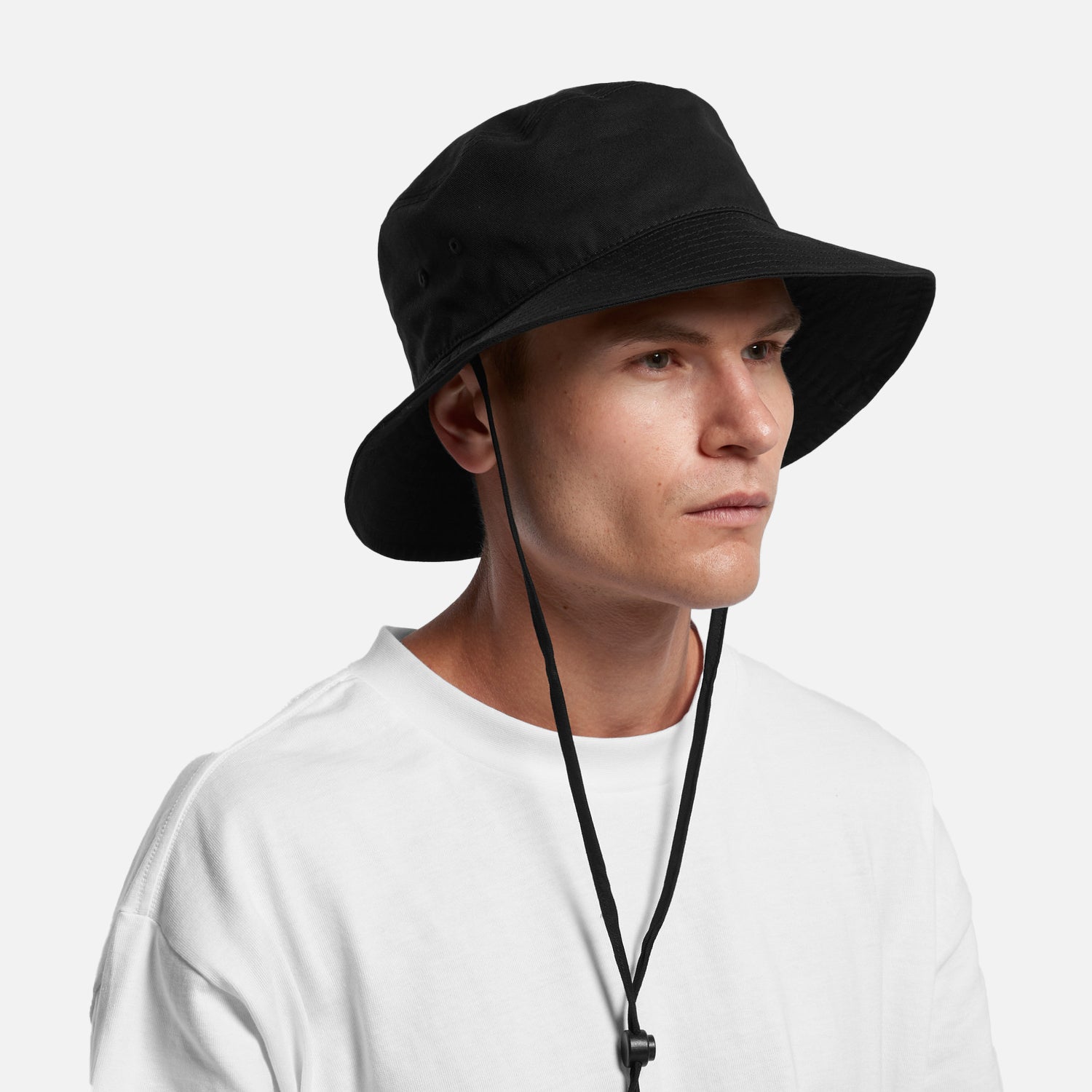 Male model wearing Look Design custom branded bucket hat in black
